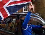 Taxi driver waves Union Flag. (Photo: Reuters)