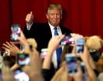 U.S. Republican presidential candidate Donald Trump greets supporters as he arrives to appear with New Jersey Governor Chris Christie at a fundraising event in Lawrenceville