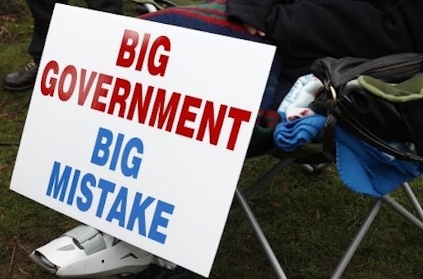 A protestor rests next to their big government big mistake sign. (Photo: Reuters)