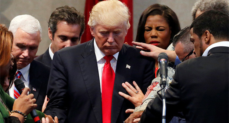 Members of the clergy lay hands and pray over Republican presidential nominee Donald Trump at the New Spirit Revival Center in Cleveland Heights, Ohio, U.S., September 21, 2016. (Jonathan Ernst/Reuters)