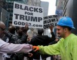 A construction worker exchanges a fist bump with pro-Trump supporters who gathered to cheer his election as President, Nov. 9, 2016, outside Trump Tower in New York. (Photo: AP/Associated Press)