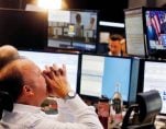 A broker reacts as the newly elected U.S. President Donald Trump shows up on a television screen at the stock market in Frankfurt, Germany. (Photo: AP)