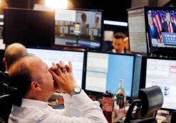 A broker reacts as the newly elected U.S. President Donald Trump shows up on a television screen at the stock market in Frankfurt, Germany. (Photo: AP)