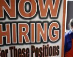 An employee at Home Depot (NYSE:HD) beyond a now hiring sign at a satellite location. (Photo: Reuters)