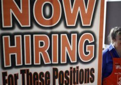 An employee at Home Depot (NYSE:HD) beyond a now hiring sign at a satellite location. (Photo: Reuters)