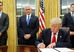 U.S. President Donald Trump, signs his first executive orders at the White House on Friday. Behind him, from left, are senior adviser Jared Kushner, Vice President Mike Pence and staff secretary Rob Porter. (Photo: Reuters)