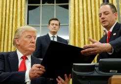 President Donald J. Trump, left, hands Chief of Staff Reince Priebus, right, an executive order in the Oval Office in Washington, Friday. (Photo: Reuters)