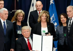 President Donald J. Trump, center, sits to the left of Vice President Mike Pence, to the right of Homeland Security Secretary John F. Kelly, while holding up an executive order to build border wall and fulfill other campaign promises related to immigration. The orders were signed at the U.S. Department of Homeland Security on Wednesday, Jan. 25, 2017 in Washington. (Photo: AP)