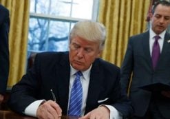 President Donald Trump signs an executive order to withdraw the U.S. from the 12-nation Trans-Pacific Partnership trade pact agreed to under the Obama administration, Monday, Jan. 23, 2017, in the Oval Office of the White House in Washington. (AP Photo/Evan Vucci)