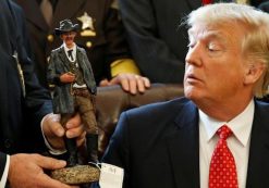 President Donald J. Trump receives a figurine of a sheriff during a meeting with county sheriffs at the White House. (Photo: Reuters)