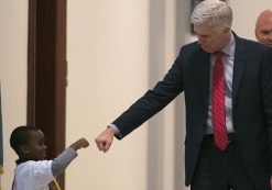 Judge Neil Gorsuch, who served on the 10th Circuit before being nominated to the U.S. Supreme Court by President Donald J. Trump, stops to give a young boy a fist bump before heading into the Senate confirmation hearing on Capitol Hill.