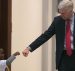 Judge Neil Gorsuch, who served on the 10th Circuit before being nominated to the U.S. Supreme Court by President Donald J. Trump, stops to give a young boy a fist bump before heading into the Senate confirmation hearing on Capitol Hill.