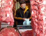 In this Jan. 22, 2003 file photo, a Chinese shopkeeper stands behind a row of beef products at an open air market in Beijing, China. China will finally open its borders to U.S. beef while cooked Chinese poultry is closer to hitting the American market as part of a U.S.-China trade agreement. Trump administration officials hailed the deal as a significant step in their efforts to boost U.S. exports and even America's trade gap with the world's second-largest economy. (Photo: AP)