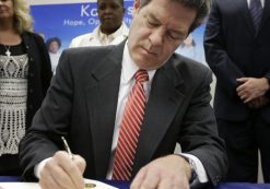 Gov. Sam Brownback signs a welfare reform bill into law in Topeka, Kan., Thursday, April 16, 2015. (Photo: AP)