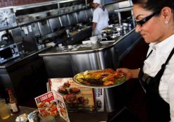 A waitress serves a steak and fried shrimp combo plate to a customer at Norms Diner on La Cienega Boulevard in Los Angeles, California May 20, 2015. (Photo: Reuters)