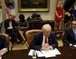 Director of the Office of Management and Budget Mick Mulvaney (L) and Treasury Secretary Steve Mnuchin (R) flank U.S. President Donald Trump as he hosts a 