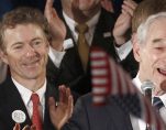 Then-Republican presidential candidate Rep. Ron Paul, a libertarian-leaning Republican from Texas, speaks to supporters as his son Sen. Rand Paul, Kty., also a libertarian-leaning Republican, applauds at his Iowa Caucus night rally in Ankeny, Iowa, January 3, 2012. (Photo: Reuters)