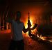 An Islamic extremist celebrates as the U.S. Consulate in Benghazi burns after the terror attack that claimed the lives of 4 Americans on September 11, 2012. (Photo: Reuters)