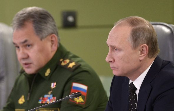 Russian President Vladimir Putin, right, with Defence Minister Sergei Shoigu, left, attend a meeting on Russian air force's activity in Syria at the national defense control center in Moscow, Russia, November 17, 2015. (Photo: Reuters)