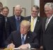 President Donald Trump signs the Presidential Space Directive - 1, directing NASA to return to the moon, alongside members of the Senate, Congress, NASA, and commercial space companies in the Roosevelt room of the White House in Washington, Monday, Dec. 11, 2017. Photo Credit: (NASA/Aubrey Gemignani)