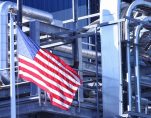 An American Flag flying in front of a U.S. manufacturing factory. (Photo: AdobeStock)