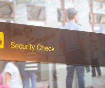 Double exposure of security check airport sign. Airport security check at gates with metal detector and scanner. (Photo: AdobeStock)