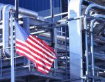 An American Flag flying in front of a U.S. manufacturing factory. (Photo: AdobeStock)