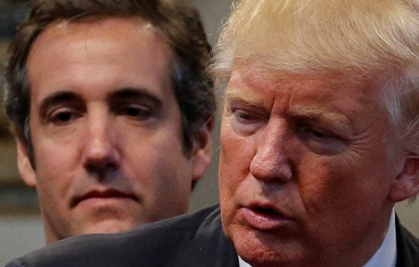 Former attorney Michael Cohen stands behind Donald Trump. (Photo: Screenshot Google News)