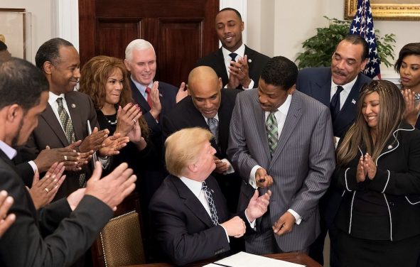 Donald Trump hands a pen to Isaac Newton Farris Jr. after signing a proclamation in honor of Martin Luther King Jr. Day. January 2018. (Photo: Official White House)