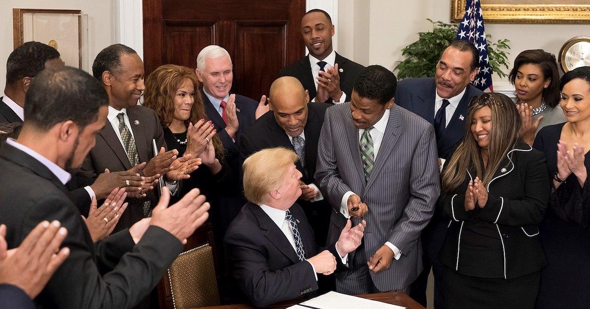 Donald Trump hands a pen to Isaac Newton Farris Jr. after signing a proclamation in honor of Martin Luther King Jr. Day. January 2018. (Photo: Official White House)