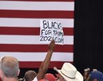 An African American supporter of President Donald Trump holds up a Black for Trump sign during a rally in Tampa, Florida on Tuesday, July 31, 2018. (Photo: Laura Baris/People's Pundit Daily)