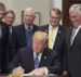 President Donald Trump signs the Presidential Space Directive - 1, directing NASA to return to the moon, alongside members of the Senate, Congress, NASA, and commercial space companies in the Roosevelt room of the White House in Washington, Monday, Dec. 11, 2017. Photo Credit: (NASA/Aubrey Gemignani)