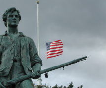 Summer's End. Lexington Green, 11 September 2002. Photo taken in Minute Man National Historical Park, with flag at half staff on the first anniversary of the terrorist attacks of 11 September 2001. Sculpture : 