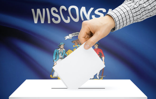 Voting, elections and state polls concept: Ballot box with state flag in the background - Wisconsin. (Photo: AdobeStock)