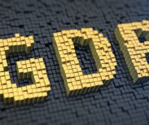 Gross domestic product (GDP) graphic concept with yellow square pixels on a black matrix background. (Photo: AdobeStock)