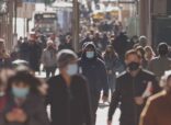 Crowd of people walking the city streets while wearing masks during the coronavirus (Covid-19) pandemic. (Photo: AdobeStock)